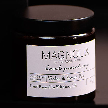 Hyacinth Scented Candle - 96g - Magnolia the Florist Indulge in the luxurious aroma of our hyacinth-scented jar candle. Crafted with a delicate blend of essential oils, this candle fills the air with the enchanting fragrance of fresh hyacinths. Perfect for creating a sophisticated and exclusive ambience in any space. Enjoy the aromatic benefits while enhancing any room with a touch of elegance, made with a professional blend of scented oil & emollient wax balm.