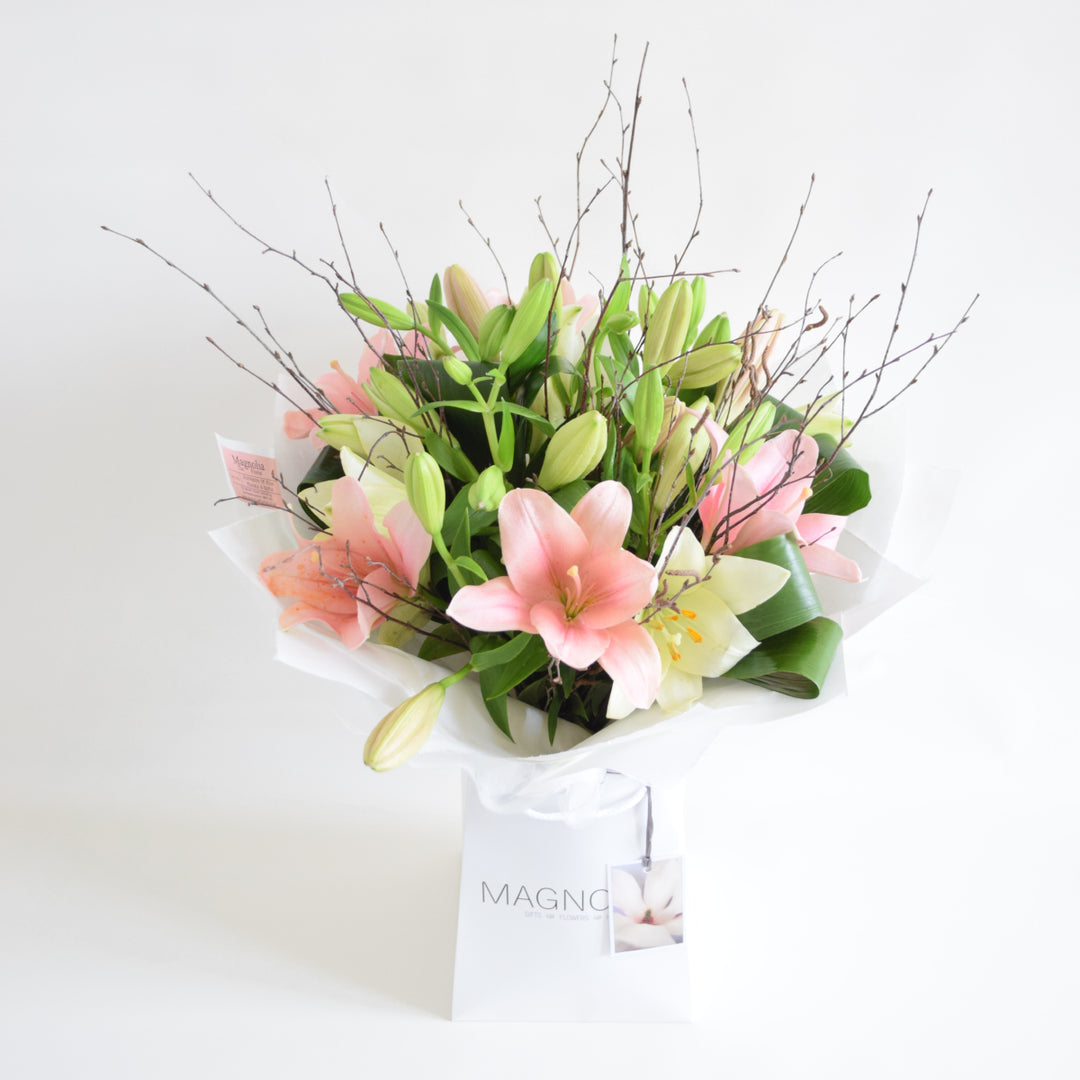 Balmoral Hand-Tied Bouquet - Magnolia the Florist The Balmoral Hand-Tied Bouquet from Magnolia the Florist, features a beautiful selection of lilies in your choice of pink, white, or mixed. Expertly hand-tied and presented in our signature box bag, this bouquet makes a stunning and elegant gift for any occasion. Enjoy the beauty and fragrance of fresh flowers with our hand-tied bouquet.