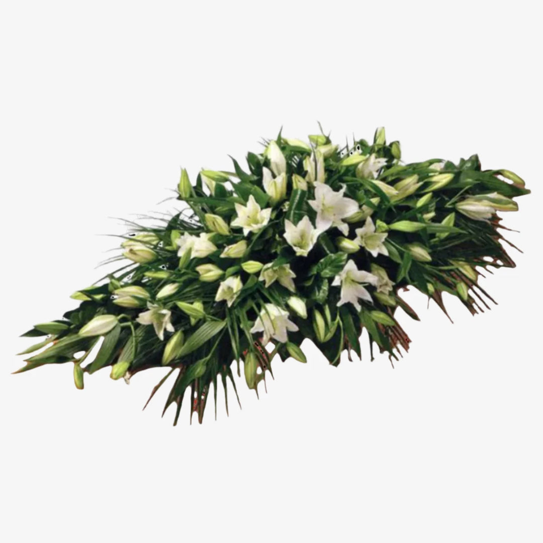 Lily Casket Spray - Magnolia the Florist Oriental Lilies are beautifully set off by an array of luxurious deep green leaves to create this simple but striking Lily Casket Spray. You also have the colour options of White or Pink. The image shows the White option. If you cannot find what you want on our site, please call our sales team, we're always happy to assist you. This item requires 5 days notice to order.