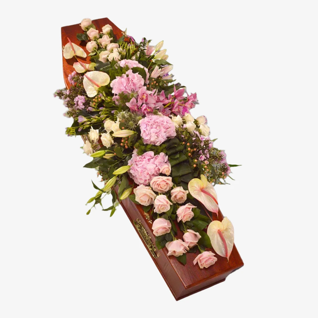 Contemporary Casket Spray - Magnolia the Florist This contemporary casket spray features a modern design filled with a variety of flowers in pink tones, including Roses, Hydrangea, Anthurium, and lilies. This elegant arrangement adds a touch of sophistication to any funeral service. If you cannot find what you want on our site, please call our sales team, we're always happy to assist you. This item requires 5 days notice to order.