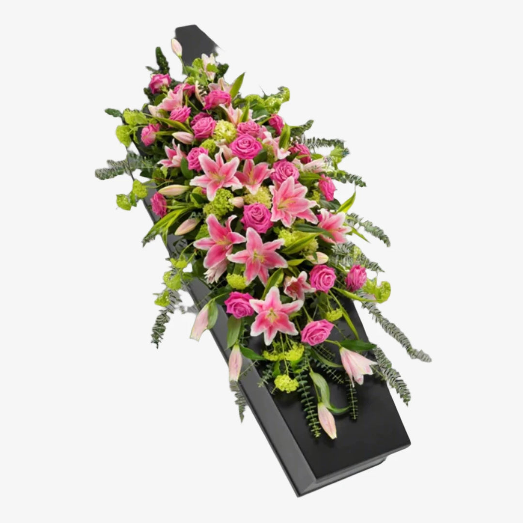 Rose & Lily Casket Spray - Magnolia the Florist This elegant casket spray features a delicate mix of lilies, roses, and foliage. The arrangement is a beautiful and heartfelt way to honour and pay tribute to your loved one. You also have the colour options of White or Pink. The image shows the Pink option. If you cannot find what you want on our site, please call our sales team, we're always happy to assist you. This item requires 5 days notice to order.