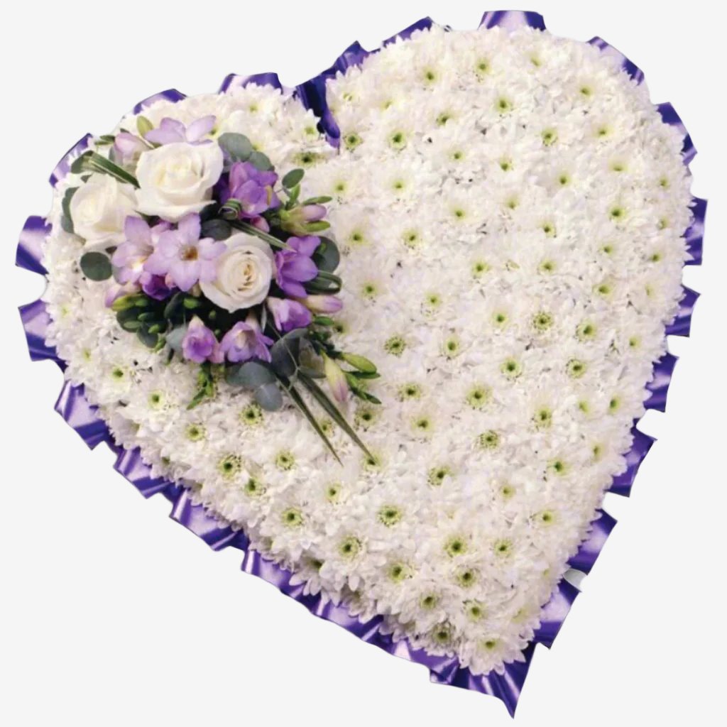 Based Heart - Magnolia the Florist A 15" classic heart-shaped design covered with a mass of white Double Spray Chysanthemums and finished with a spray of coloured flowers. The image shows a spray colour selection of Lilac, though other colour options are available. Please select your option below. If you cannot find what you want on our site, please call our sales team, we're always happy to assist you This item requires 2 days notice to order.