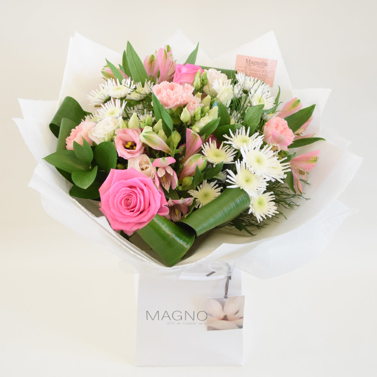 Richmond Hand-tied Bouquet - Magnolia the Florist Experience the beauty and elegance of our Richmond Hand-tied Bouquet from Magnolia the Florist. This stunning arrangement of pink and white tones includes roses, alstroemeria, lisianthus, carnations, chrysanthemums, and foliage. All hand-tied and presented in our signature box bag. Perfect for any occasion, this bouquet is sure to impress.