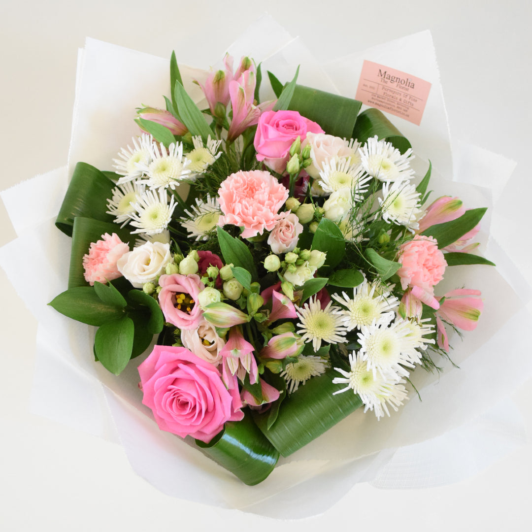 Richmond Hand-tied Bouquet - Magnolia the Florist Experience the beauty and elegance of our Richmond Hand-tied Bouquet from Magnolia the Florist. This stunning arrangement of pink and white tones includes roses, alstroemeria, lisianthus, carnations, chrysanthemums, and foliage. All hand-tied and presented in our signature box bag. Perfect for any occasion, this bouquet is sure to impress.