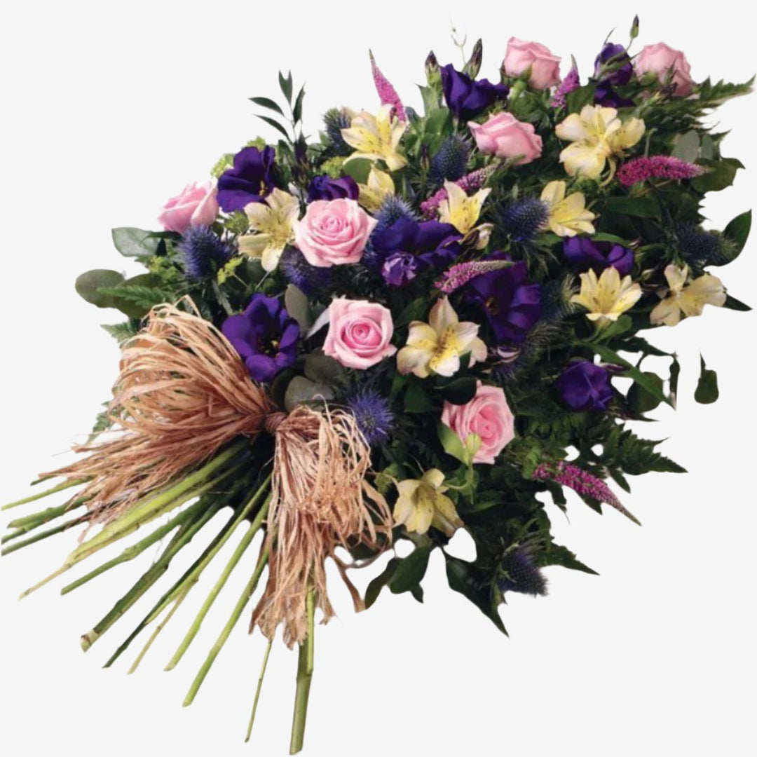 Woodland Single-Ended Spray - Magnolia the Florist Large-headed Roses, Lisianthus, Alstroemeria and Veronica in pretty pinks, lilacs and creams are set off by blue Eryngium, luxury foliages and a raffia bow to create this woodland single-ended spray. Single Ended Sprays have an approximate length of 55 cm. If you cannot find what you want on our site, please call our sales team, we're always happy to assist you This item requires 2 days notice to order.