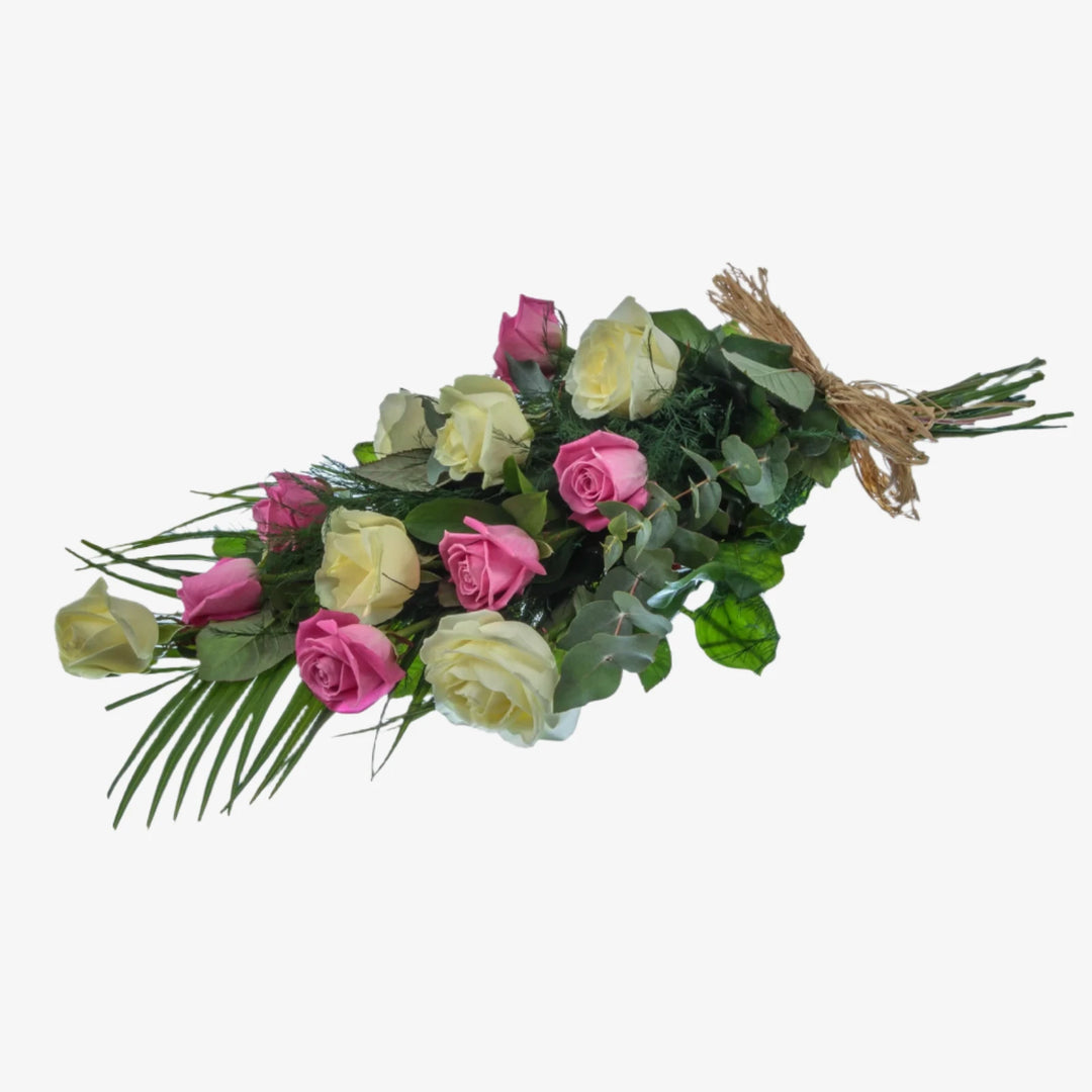 12 Rose Hand-Tied Sheaf - Magnolia the Florist 12 large-headed Roses are presented with a selection of foliage to create this classic Rose sheaf. The image shows the colour option of White and Pink Roses, although other options are available. Please select your colour option below. If you cannot find what you want on our site, please call our sales team, we're always happy to assist you. This item requires 1 day notice to order.