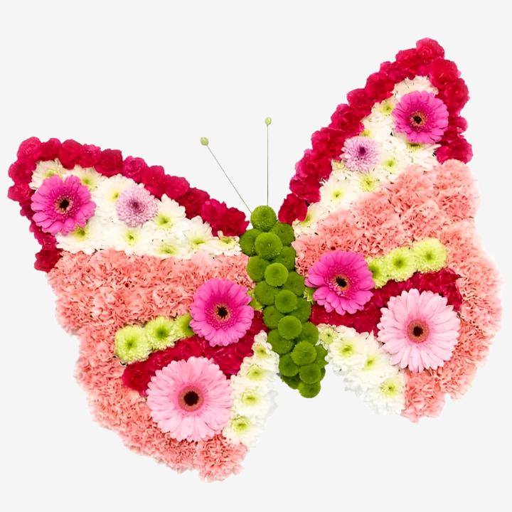 Butterfly - Magnolia the Florist A pretty pink butterfly wreath in fresh flowers. Approx Size is 20" x 23" If you cannot find what you want on our site, please call our sales team, we're always happy to assist you This item requires 5 days notice to order.