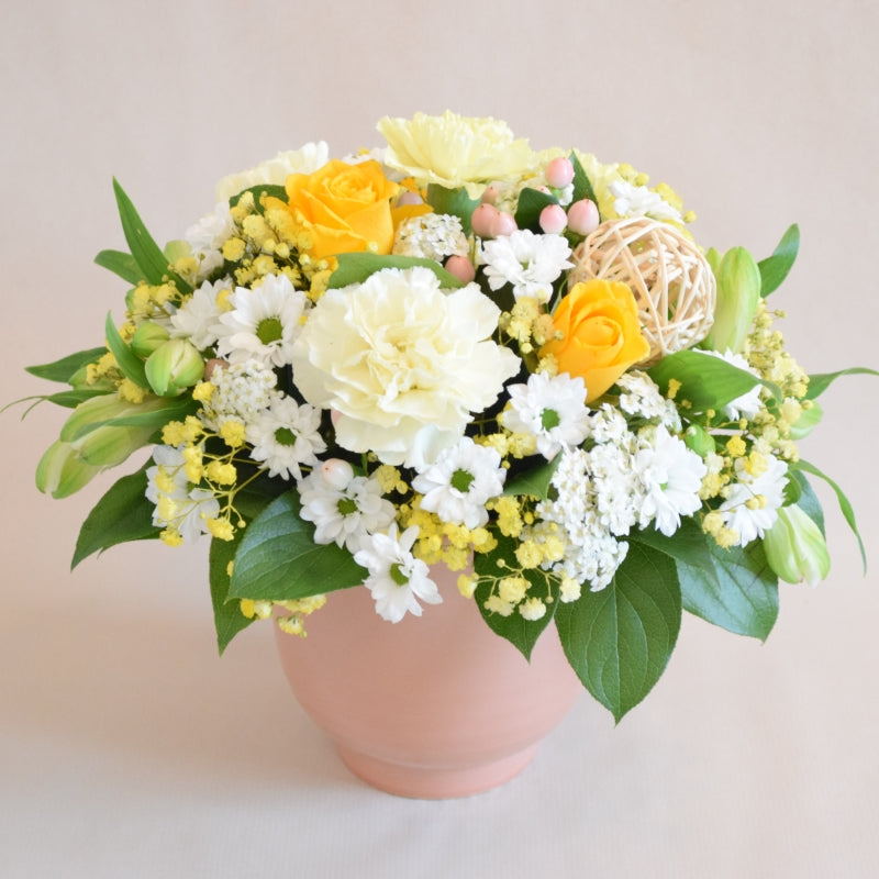 Lambeth Arrangement - Magnolia the Florist At Magnolia the Florist, we present our exquisite Lambeth Arrangement, a perfect no-fuss floral gift! A stunning floral display of yellow and white florist-choice flowers, arranged in floral foam, and presented in a wonderful ceramic container. For scale the container is approximately 14cm high by 13 cm width and due to stock variations, the colour of the container may vary from the image shown.