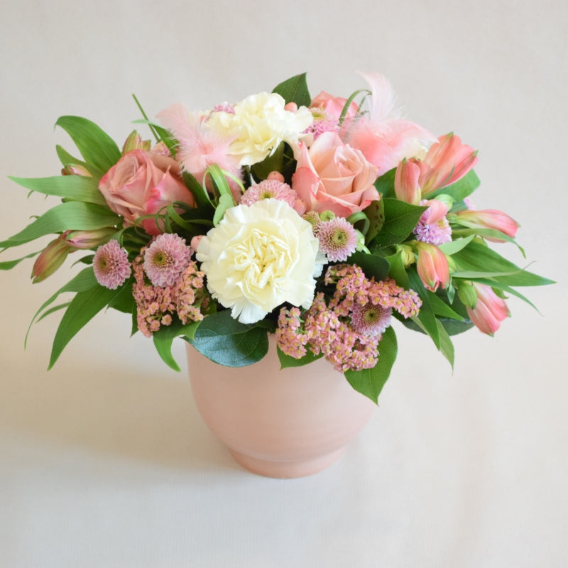 Bexley Arrangement - Magnolia the Florist At Magnolia the Florist, we present to you our exquisite Bexley Arrangement, a perfect no-fuss floral gift! A stunning floral display of pink and white florist-choice flowers, arranged in floral foam, and presented in a wonderful ceramic container. For scale the container is approximately 14cm high by 13 cm width and due to stock variations, the colour of the container may vary from the image shown.